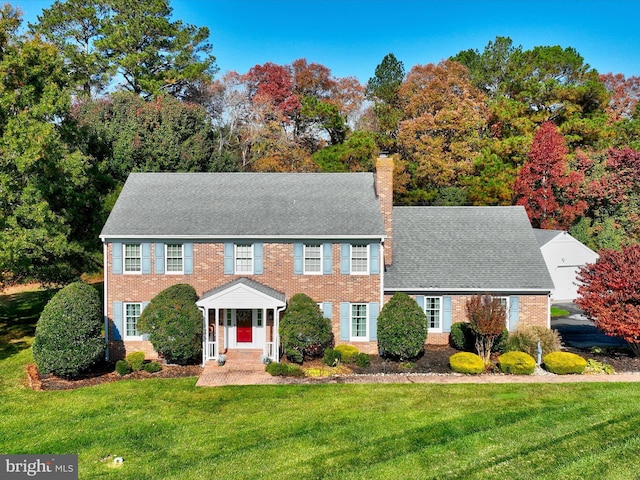 30602 Foxchase Dr, Salisbury, MD 21804 - colonial home with a chimney, a front yard, and brick siding