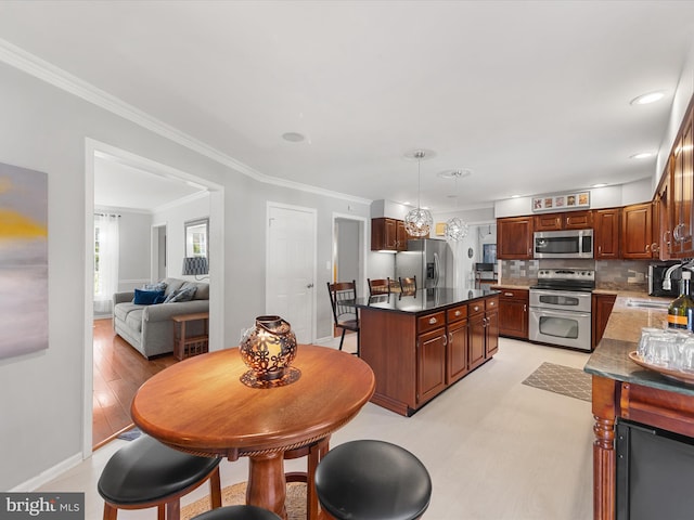 kitchen with decorative backsplash, appliances with stainless steel finishes, light wood-type flooring, pendant lighting, and crown molding