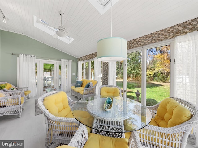 sunroom / solarium featuring wood ceiling, lofted ceiling with skylight, and ceiling fan