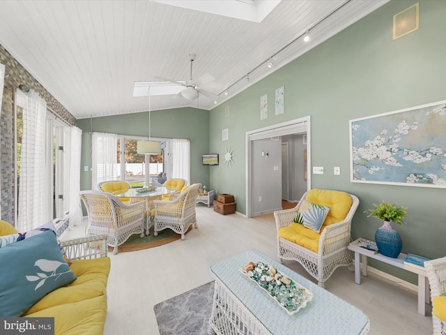 interior space with wooden ceiling, vaulted ceiling, rail lighting, light wood-type flooring, and ceiling fan