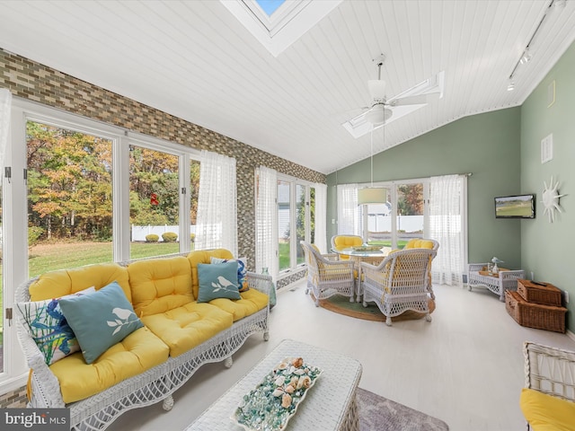 sunroom featuring a wealth of natural light, vaulted ceiling with skylight, wooden ceiling, and ceiling fan