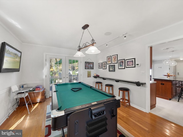 game room with pool table, light hardwood / wood-style flooring, french doors, and crown molding