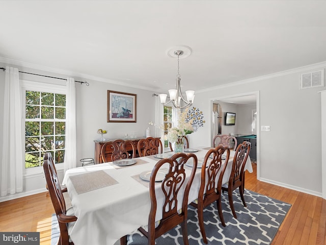 30602 Foxchase Dr, Salisbury, MD 21804 - dining room with visible vents, ornamental molding, an inviting chandelier, and light wood-style floors