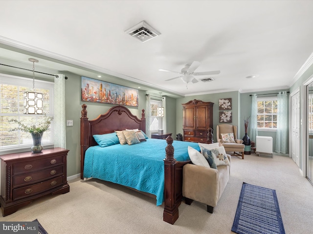 bedroom with crown molding, light carpet, and ceiling fan