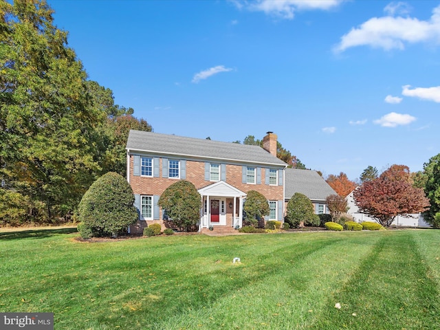 30602 Foxchase Dr, Salisbury, MD 21804 - colonial home with brick siding, a chimney, and a front yard
