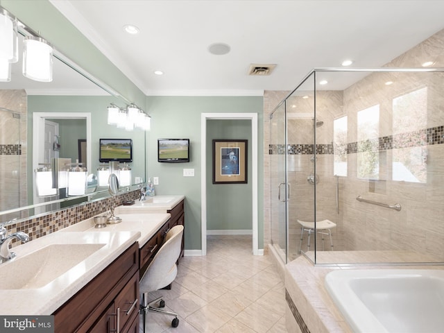 bathroom with vanity, ornamental molding, a healthy amount of sunlight, and independent shower and bath