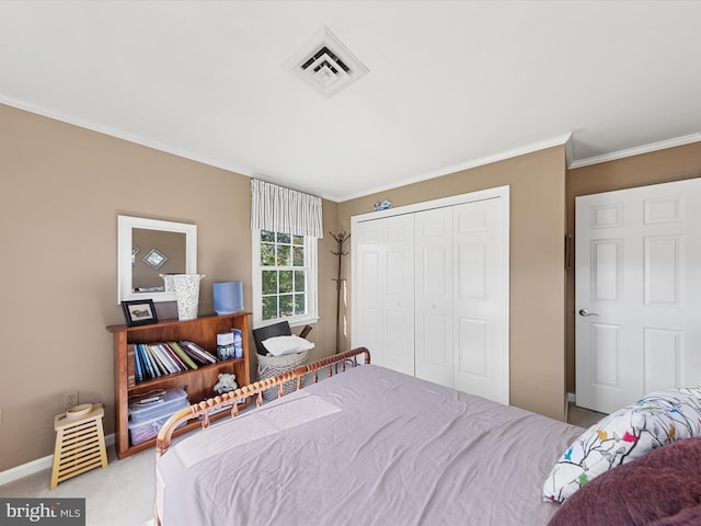 carpeted bedroom with ornamental molding and a closet