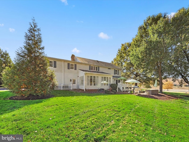 30602 Foxchase Dr, Salisbury, MD 21804 - back of house with a lawn, a chimney, and a sunroom