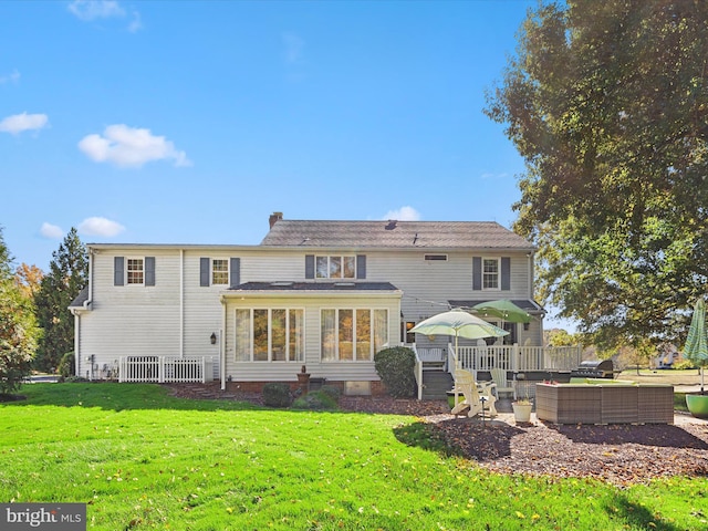 back of property with a yard and a patio area