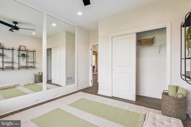 bedroom featuring ceiling fan, a closet, and dark hardwood / wood-style floors