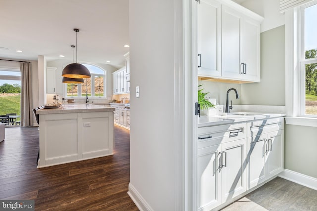 kitchen featuring white cabinets and plenty of natural light