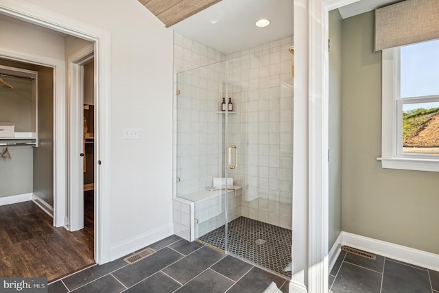 bathroom featuring an enclosed shower and hardwood / wood-style flooring