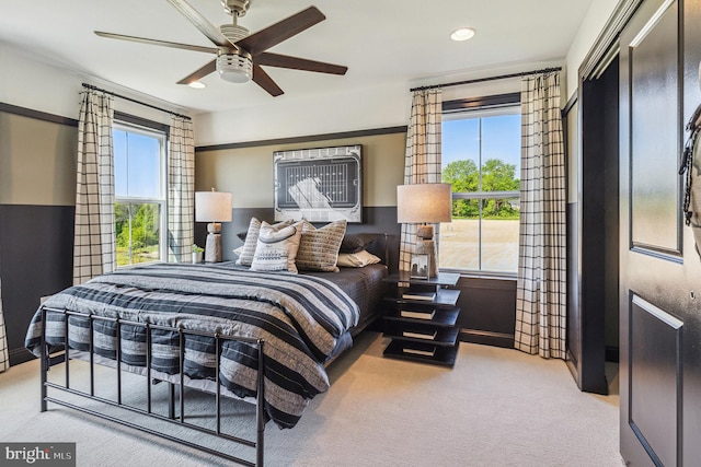 bedroom featuring ceiling fan and light carpet