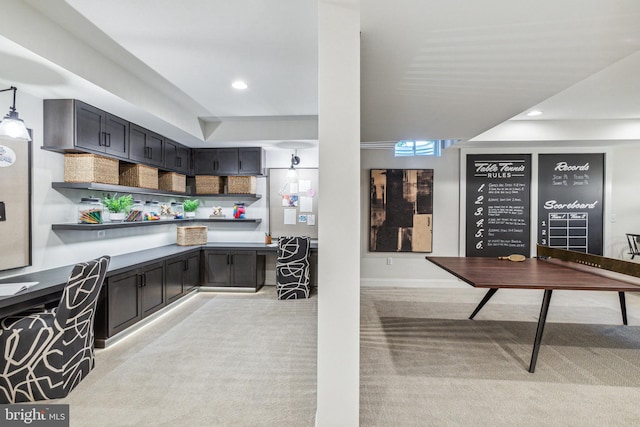 kitchen featuring pendant lighting and light colored carpet