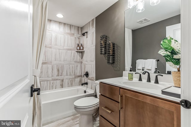 full bathroom featuring toilet, vanity, and tiled shower / bath