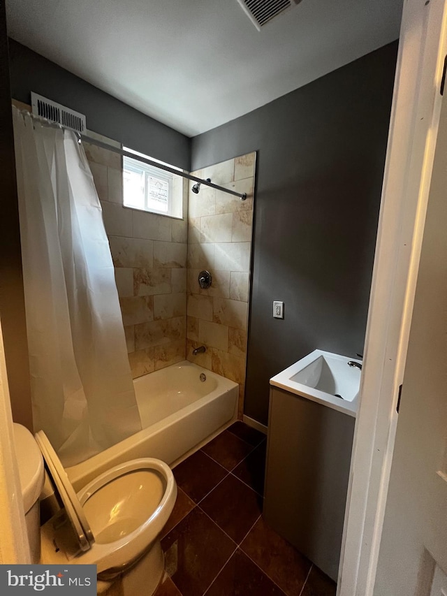 full bathroom featuring tile patterned flooring, vanity, toilet, and shower / tub combo