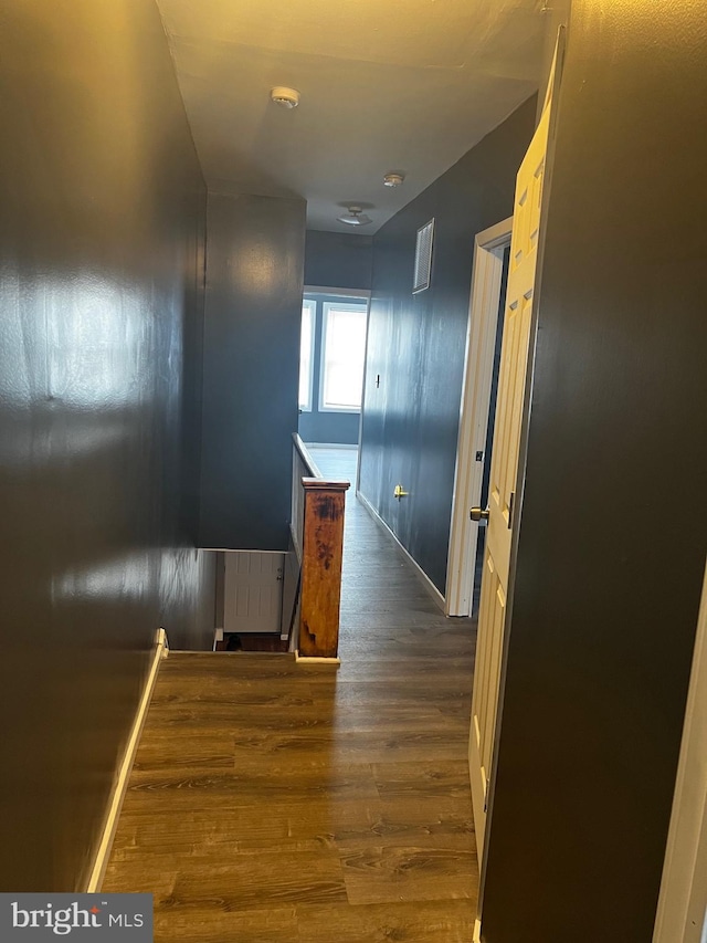 hallway with dark hardwood / wood-style flooring