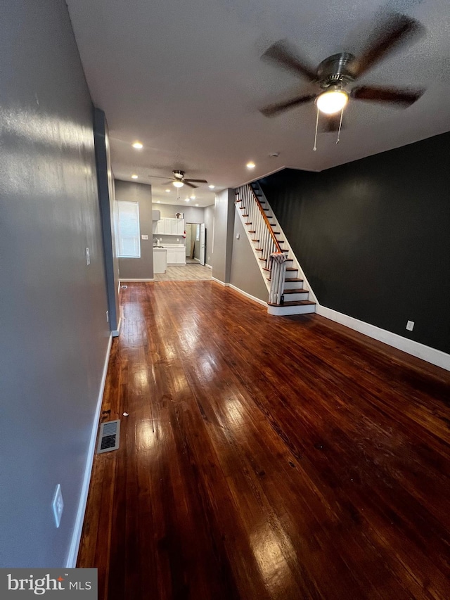 unfurnished living room with hardwood / wood-style flooring and a textured ceiling