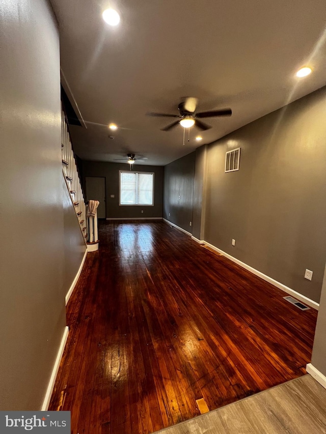 empty room with dark hardwood / wood-style floors and ceiling fan