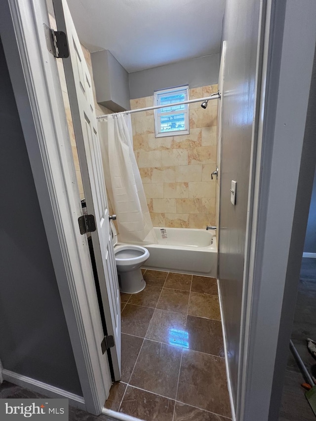 bathroom featuring tile patterned floors, toilet, and shower / bathtub combination with curtain