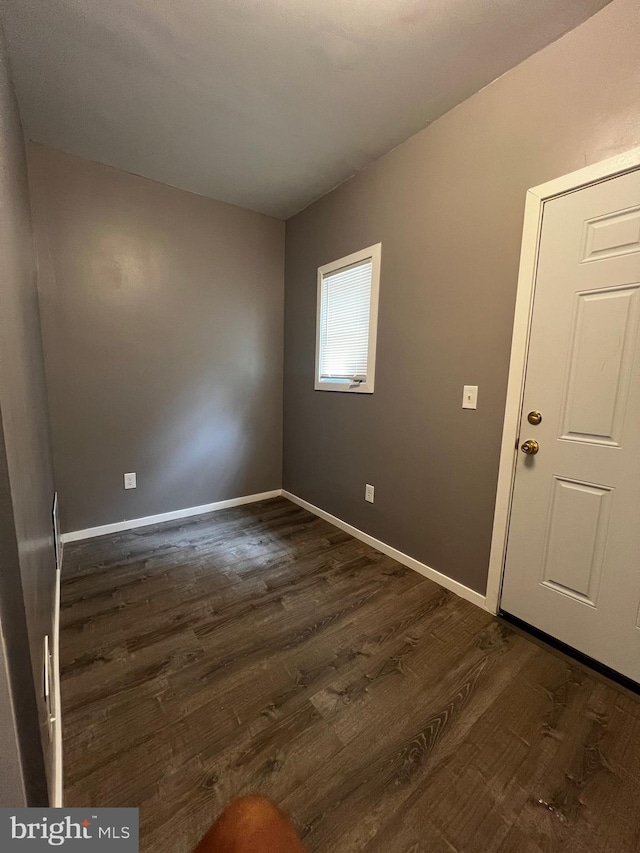 spare room with dark hardwood / wood-style floors