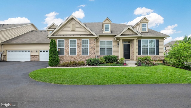 view of front of property with a front lawn and a garage