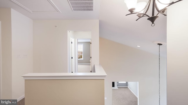 corridor featuring carpet and a chandelier