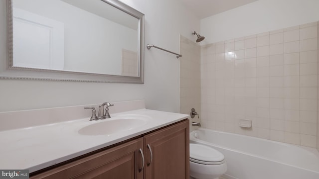 full bathroom featuring toilet, vanity, and tiled shower / bath