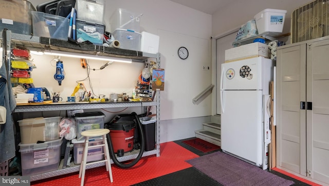 kitchen with white cabinets, white refrigerator, and dark carpet