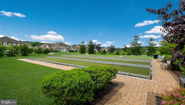 view of property's community featuring a yard