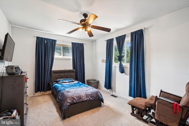 bedroom featuring ceiling fan, carpet flooring, visible vents, and baseboards