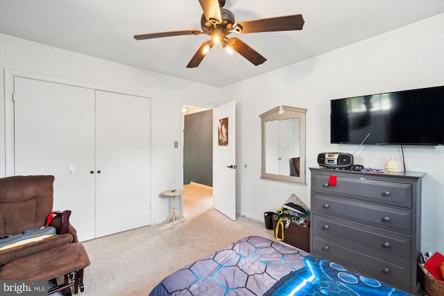 carpeted bedroom with a closet and ceiling fan