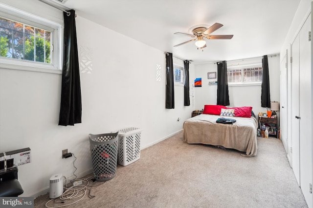 carpeted bedroom with ceiling fan and baseboards