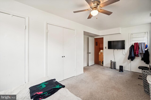 interior space featuring a ceiling fan and light colored carpet