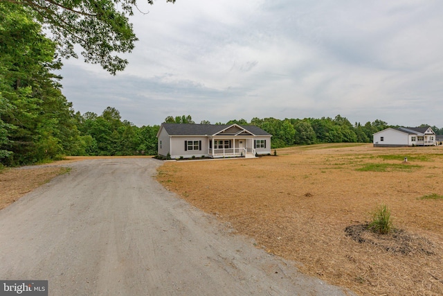 single story home featuring covered porch