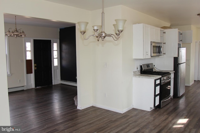 kitchen featuring white cabinetry, dark wood-type flooring, stainless steel appliances, a baseboard heating unit, and pendant lighting