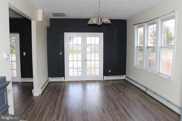 unfurnished dining area with a notable chandelier, a healthy amount of sunlight, baseboard heating, and dark wood-type flooring