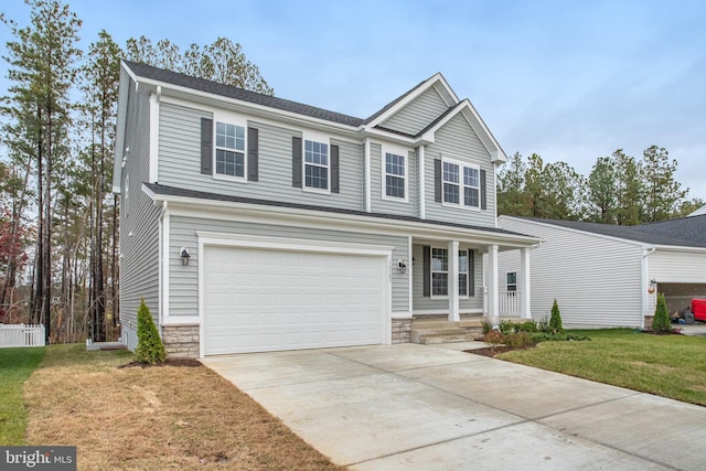 view of front property featuring a front yard and a garage