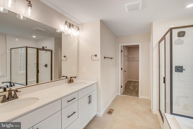 bathroom featuring tile patterned flooring, vanity, and an enclosed shower