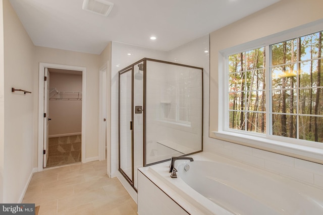 bathroom with separate shower and tub, plenty of natural light, and tile patterned flooring