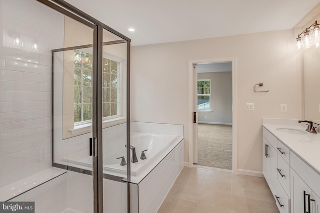 bathroom featuring tile patterned flooring, vanity, and shower with separate bathtub