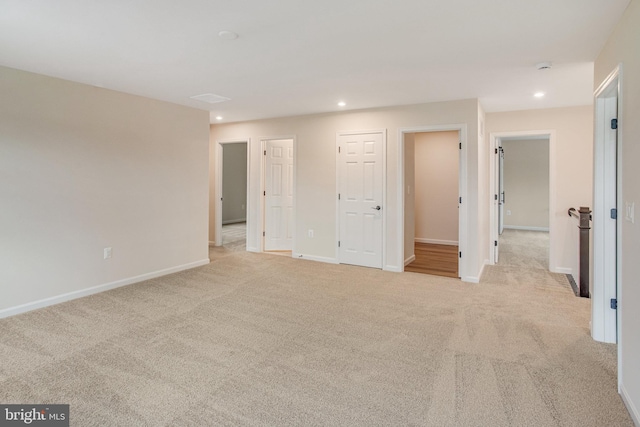 unfurnished bedroom with light colored carpet