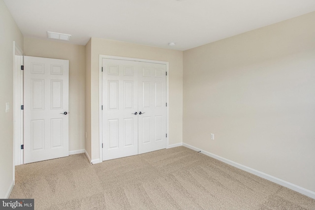 unfurnished bedroom with a closet and carpet floors