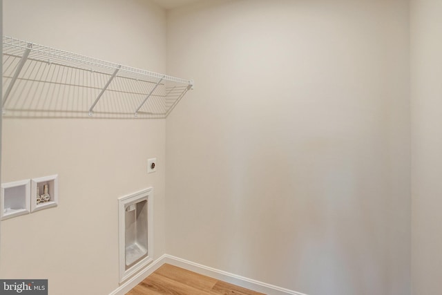 washroom with hookup for a washing machine, wood-type flooring, and hookup for an electric dryer