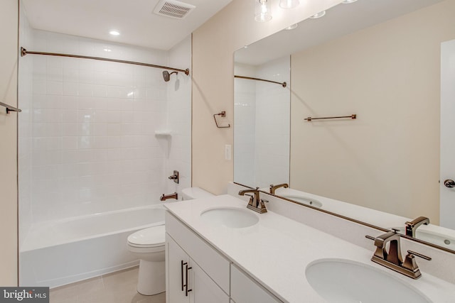 full bathroom featuring tile patterned floors, vanity, toilet, and tiled shower / bath