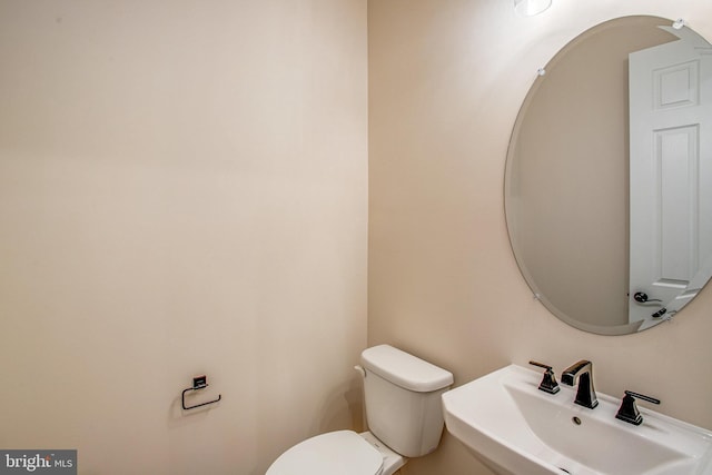 bathroom with toilet and sink