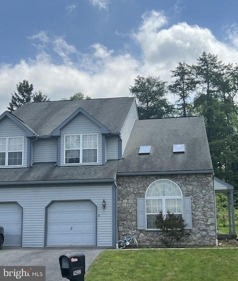 view of front of home with a garage and a front lawn