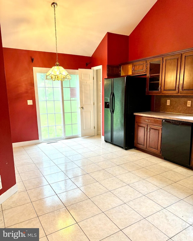 kitchen featuring tasteful backsplash, vaulted ceiling, black appliances, pendant lighting, and a notable chandelier