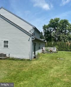 view of side of home featuring a yard