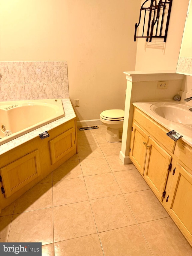 bathroom with a tub to relax in, tile patterned flooring, vanity, and toilet